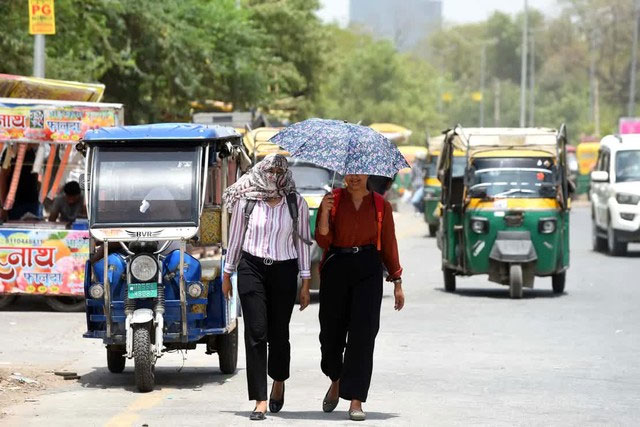 Người dân tự bảo vệ mình khỏi cái nóng mùa hè ở Gurugram, Ấn Độ vào ngày 18/ 6/2024.